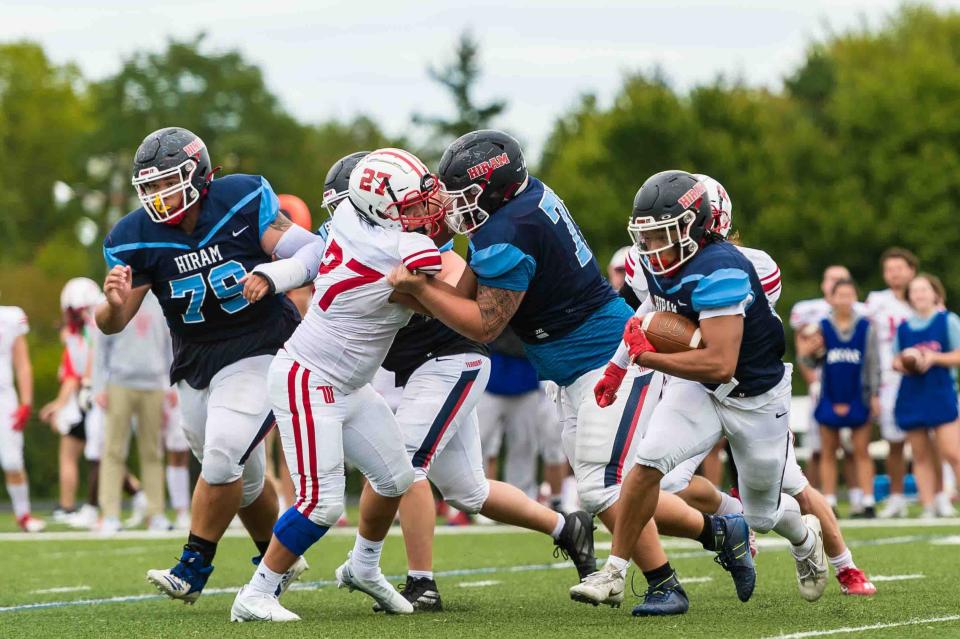 Lineman Derek Hurst (center), a Minerva High School graduate, has played in every football game during his first two years at Hiram.