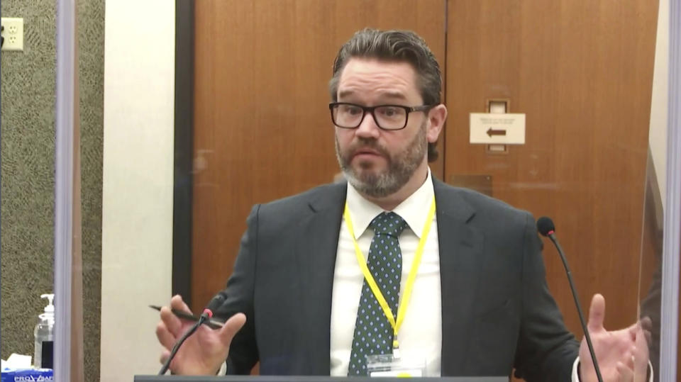 In this image taken from video, defense attorney Eric Nelson questions witness Los Angeles police department Sgt. Jody Stiger, as Hennepin County Judge Peter Cahill presides Wednesday, April 7, 2021, in the trial of former Minneapolis police Officer Derek Chauvin at the Hennepin County Courthouse in Minneapolis. Chauvin is charged in the May 25, 2020 death of George Floyd. (Court TV via AP, Pool)