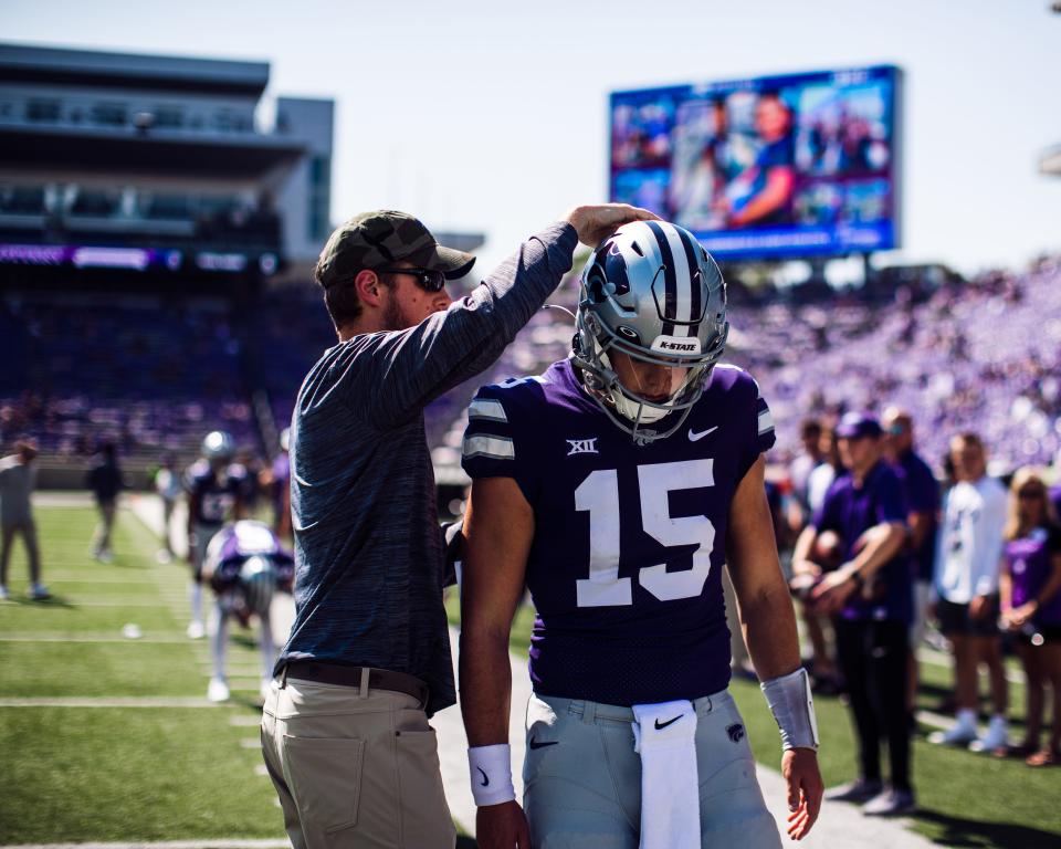 Kansas State offensive coordinator Collin Klein, left, talks to quarterback Will Howard on the sideline during the 2021 season.