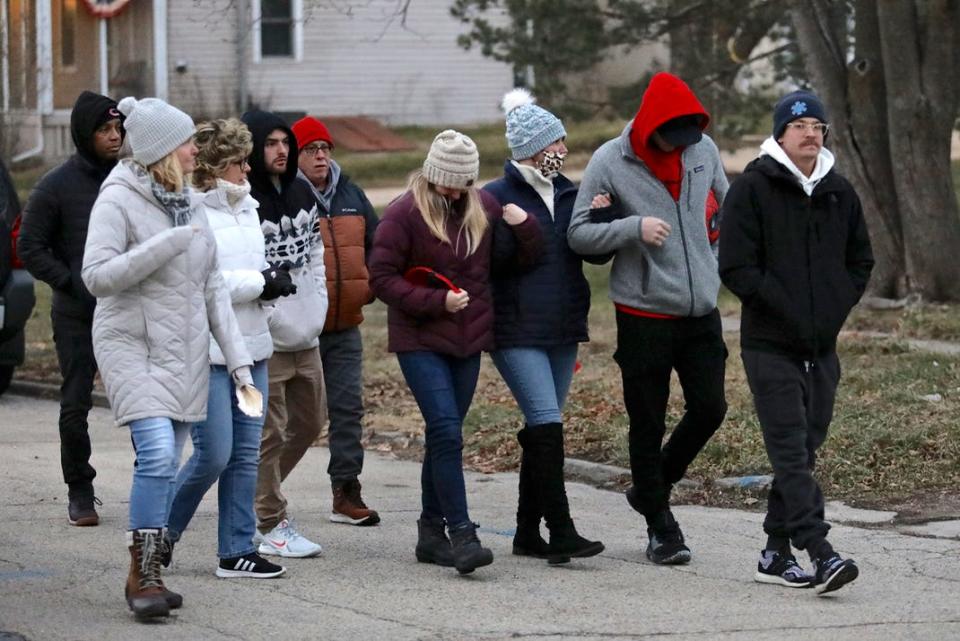Family and supporters of homicide victims Andrew Hintt and his two sons arrive for a candlelight vigil on Tuesday, Dec. 21, 2021, in the 600 block of Union Avenue in Belvidere.