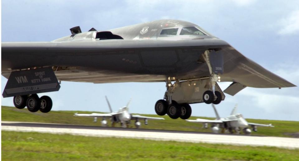 The B-2 <em>Spirit of Kitty Hawk</em> lands at Andersen Air Force Base, Guam for a deployment to the Pacific. <em>U.S. Air Force photo by Senior Airman Josshua Strang</em> Another shot of the B-2’s scoop-like auxiliary air inlets in use. (U.S. Air Force photo by Senior Airman Josshua Strang)