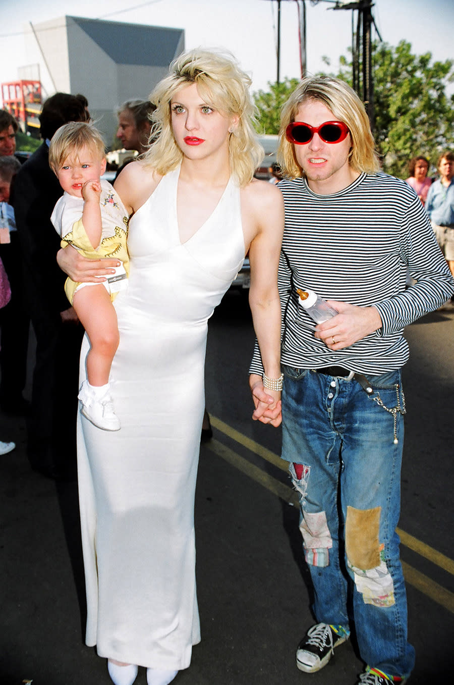 Kurt Cobain wearing patchwork denim with Courtney Love, who is carrying Frances Bean Cobain, at the 1993 MTV Video Music Awards.