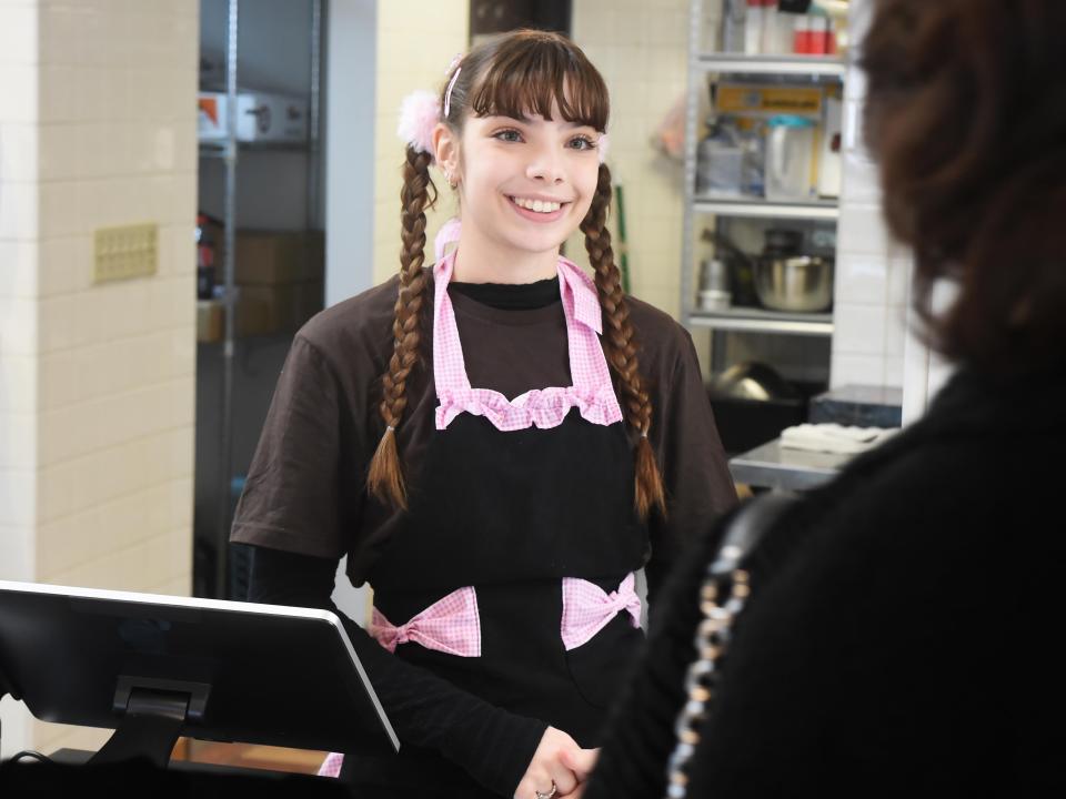 Eliza Claudio, 20, helps a customer at Casa Cafe, a new Mexican bakery in Millcreek Township.