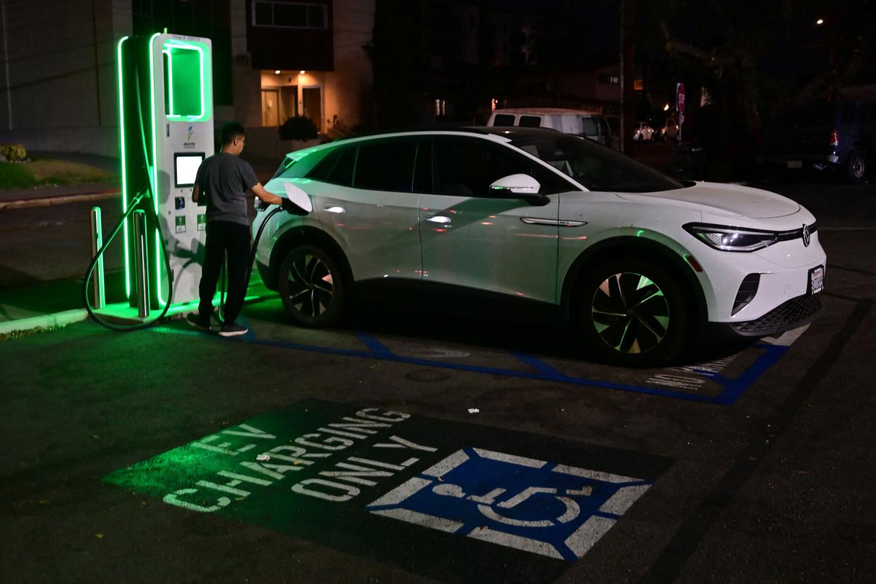 A driver charges his electric vehicle at a charging station as the California Independent System Operator announced a statewide electricity Flex Alert urging conservation to avoid blackouts in Monterey Park, Calif. on Aug. 31, 2022.