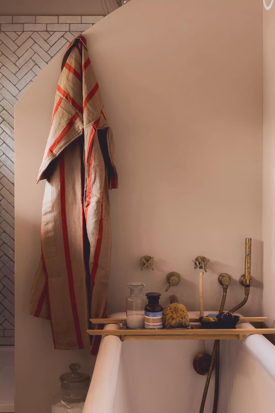 a towel on a wall in a bathroom with weekender pink paint on the walls