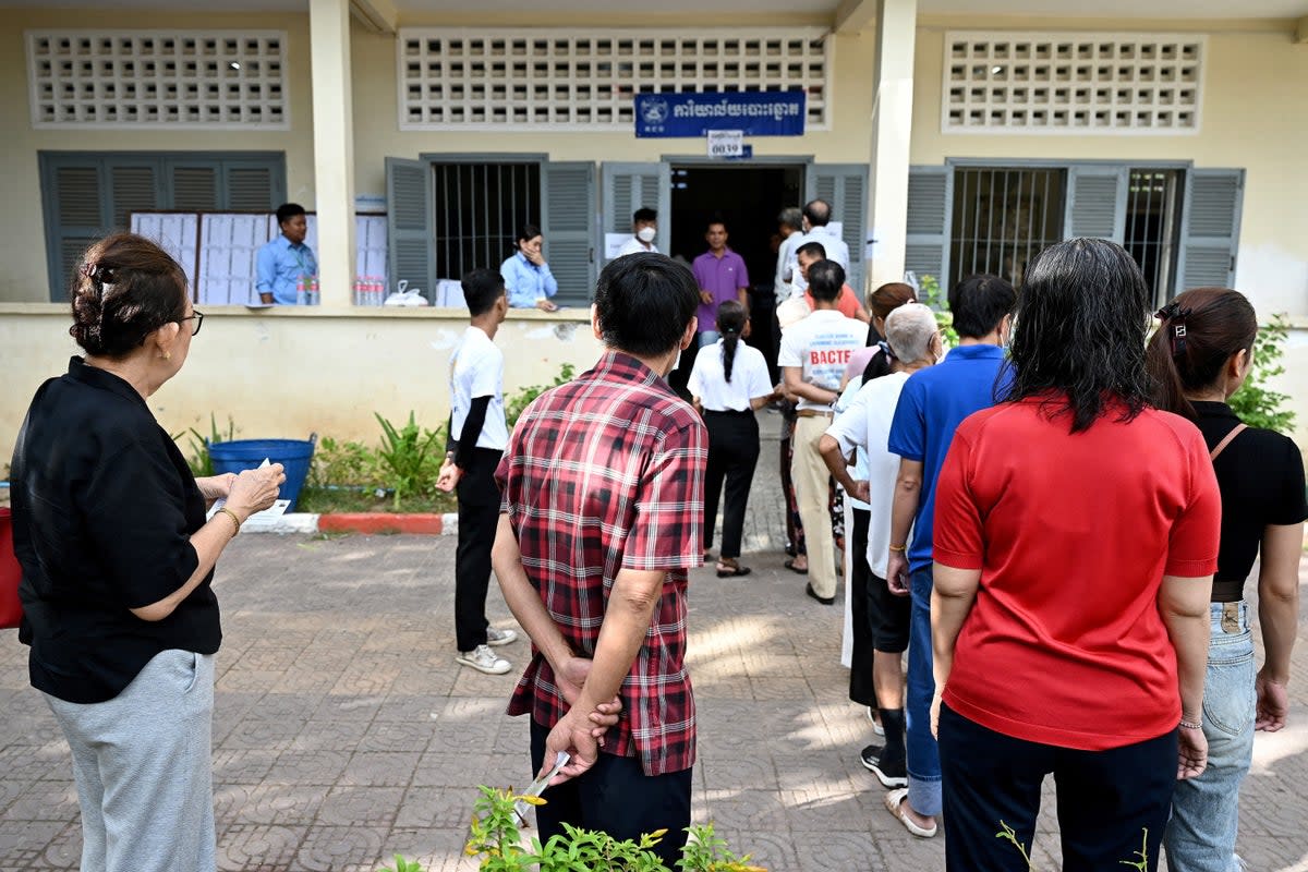 People line up to cast their votes at a polling station in Phnom Penh on 23 July, 2023 during the general election (AFP via Getty Images)