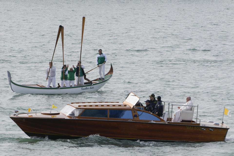 Pope Francis is greeted by gondoliers upon his arrival in Venice, Italy, Sunday, April 28, 2024. The Pontiff arrived for his first-ever visit to the lagoon town including the Vatican pavilion at the 60th Biennal of Arts. (AP Photo/Alessandra Tarantino)
