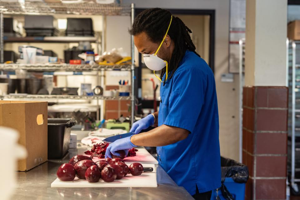 Chef Kendrick Burton chops beets inside the Southside Kitchen on August 16, 2022.