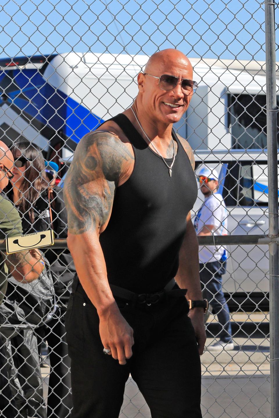 Daytona 500 grand marshal Dwayne “The Rock” Johnson walks through the garages to attend the drivers meeting before the Daytona 500 at Daytona International Speedway, Monday, Feb. 19, 2024.