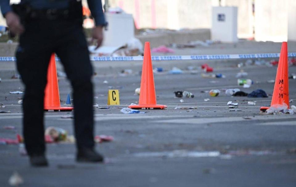 Police officers investigate the scene of a shooting where at least one person was killed and more than 20 others were injured after the Kansas City Chiefs Super Bowl LVIII victory parade on Wednesday, Feb. 14, 2024, in Kansas City.