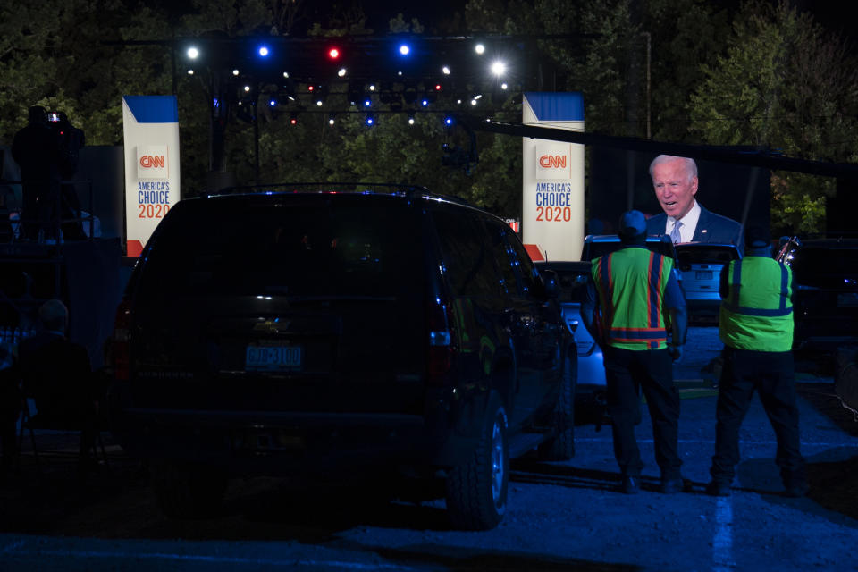 Audience members watch from their cars as Democratic presidential candidate former Vice President Joe Biden, seen on a monitor, speaks during a CNN town hall in Moosic, Pa., Thursday, Sept. 17, 2020. (AP Photo/Carolyn Kaster)