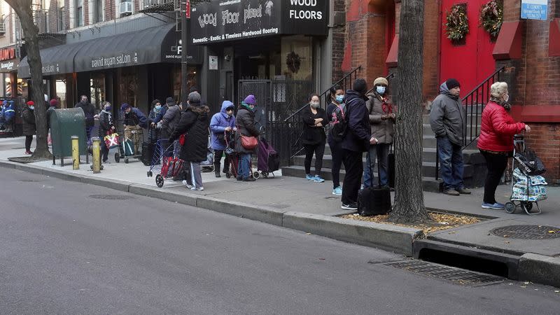 FILE PHOTO: People wait in line at the St. Clements Food Pantry in New York