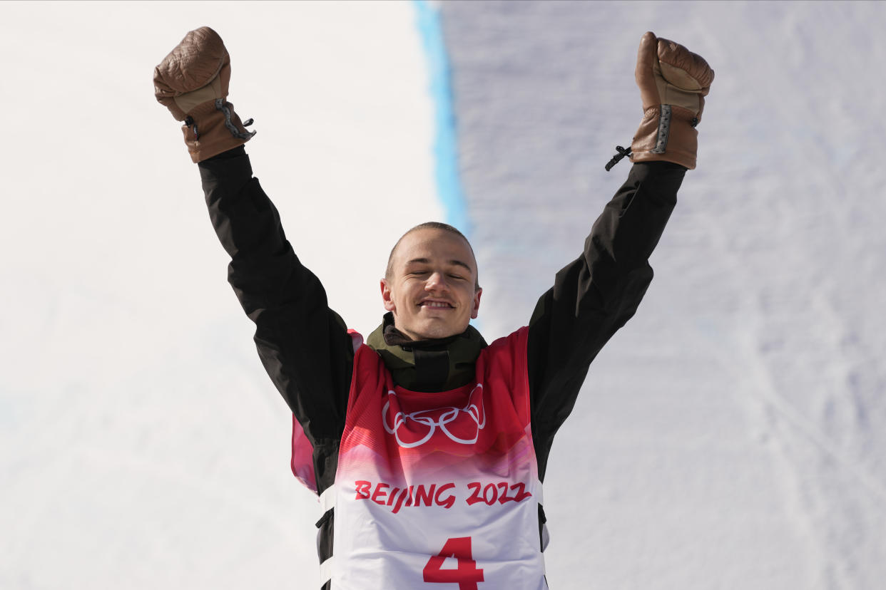 Bronze medal winner Switzerland's Jan Scherrer celebrates during the venue award ceremony for the men's halfpipe finals at the 2022 Winter Olympics, Friday, Feb. 11, 2022, in Zhangjiakou, China. (AP Photo/Francisco Seco)