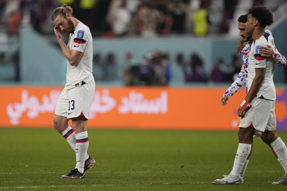 Tim Ream of the United States, left, leaves the pitch after the World Cup round of 16 soccer match between the Netherlands and the United States, at the Khalifa International Stadium in Doha, Qatar, Saturday, Dec. 3, 2022. The Netherlands won 3-1. (AP Photo/Martin Meissner)