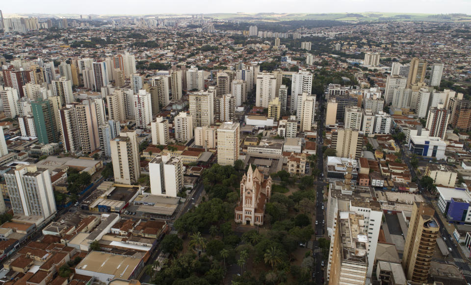 An aerial view of the Cathedral in downtown Ribeirao Preto, Sao Paulo state, Brazil, Friday, May 28, 2021. The city imposed strict shutdown measures this week to stop the spread of COVID-19, halting public transportation for the first time and closing supermarkets. (AP Photo/Andre Penner)