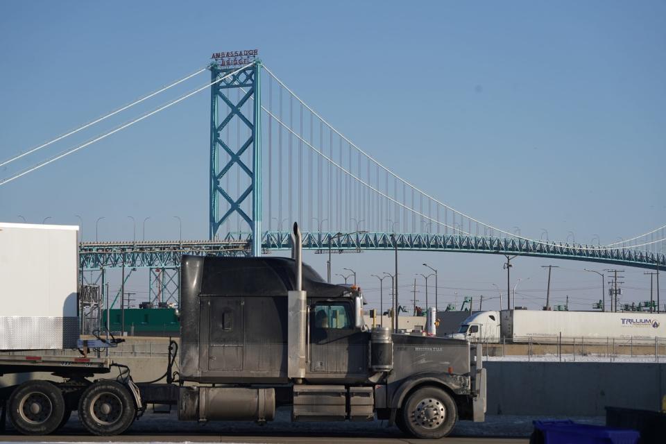 A couple of Semi-trailer trucks park along West Fisher Freeway Frontage Road as the Ambassador Bridge entrance remains closed for travel from Detroit to Canada on February 8, 2022.