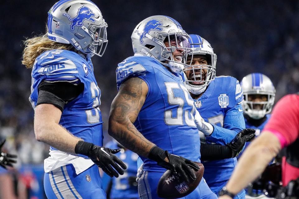 Lions linebacker Derrick Barnes, center, celebrates an interception from Buccaneers quarterback Baker Mayfield with linebackers Alex Anzalone, left, and Jalen Reeves-Maybin during the second half of the Lions' 31-23 win on Monday, Jan. 21, 2024, at Ford Field.