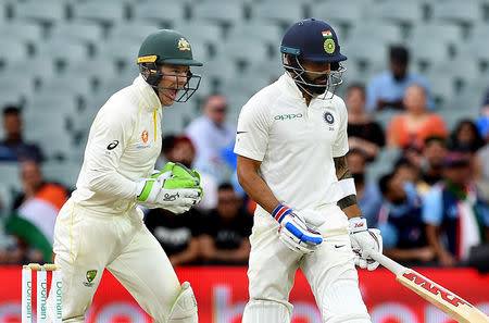 Australia's captain Tim Paine (L) celebrates as India's captain Virat Kohli leaves the field after being dismissed on day three of the first test match between Australia and India at the Adelaide Oval in Adelaide, Australia, December 8, 2018. AAP/Dave Hunt/via REUTERS