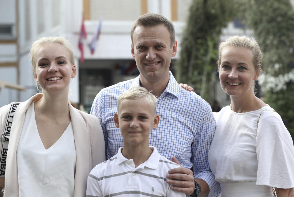 FILE - In this file photo taken on Sunday, Sept. 8, 2019, Russian opposition leader Alexei Navalny, with his wife Yulia, right, daughter Daria, and son Zakhar pose for the media after voting during a city council election in Moscow, Russia. German Chancellor Angela Merkel says Russian opposition leader Alexei Navalny was the victim of an "attempted murder by poisoning" and the aim was to silence him. Navalny was poisoned with the same type of Soviet-era nerve agent that British authorities identified in a 2018 attack on a former Russian spy, the German government said Wednesday, Sept. 2, 2020 citing new test results. (AP Photo/Andrew Lubimov, File)