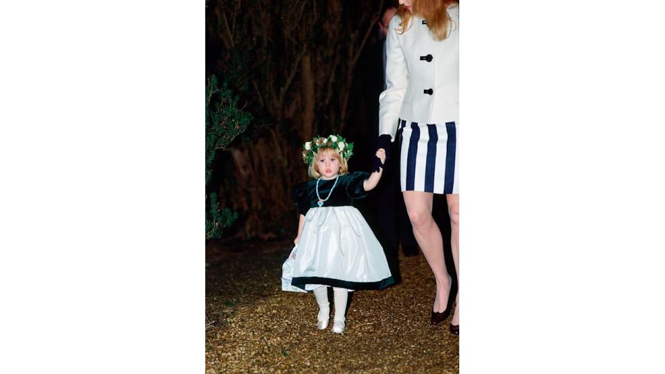 Bridesmaid Princess Beatrice holding her mother Sarah Ferguson's hand