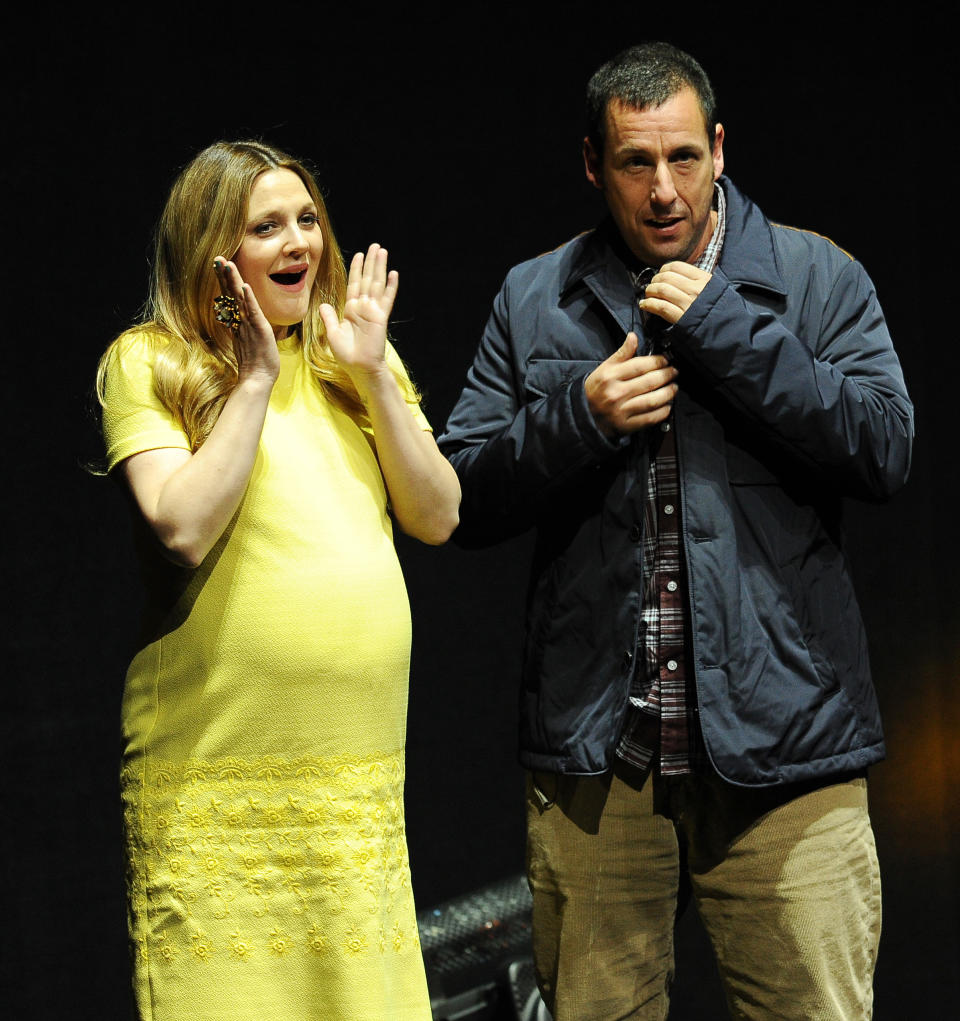 Drew Barrymore, left, a cast member in the upcoming film "Blended," is joined onstage by fellow cast member and co-producer Adam Sandler during the Warner Bros. presentation at CinemaCon 2014 on Thursday, March 27, 2014, in Las Vegas. (Photo by Chris Pizzello/Invision/AP)