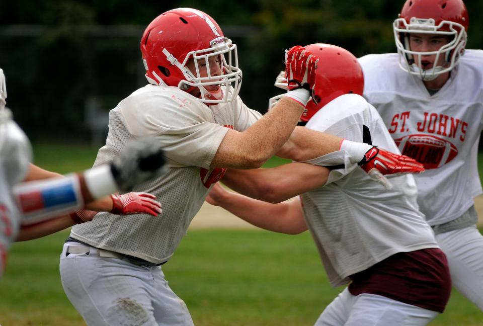 Sam Norton, left, works through special teams drills during a practice during his senior year at St. John's.