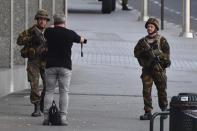 <p>Belgian Army soldiers approaches a man outside Central Station after a reported explosion in Brussels on Tuesday, June 20, 2017. Belgian media are reporting that explosion-like noises have been heard at a Brussels train station, prompting the evacuation of a main square. (AP Photo/Geert Vanden Wijngaert) </p>