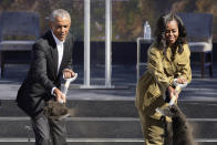 Former President Barack Obama, left, and former first lady Michelle Obama toss shovels of dirt during a groundbreaking ceremony for the Obama Presidential Center Tuesday, Sept. 28, 2021, in Chicago. (AP Photo/Charles Rex Arbogast)