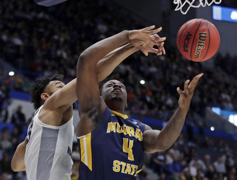 Marquette's Ed Morrow, left, blocks a shot by Murray State's Brion Sanchious (4) during the first half of a first round men's college basketball game in the NCAA Tournament, Thursday, March 21, 2019, in Hartford, Conn. (AP Photo/Elise Amendola)