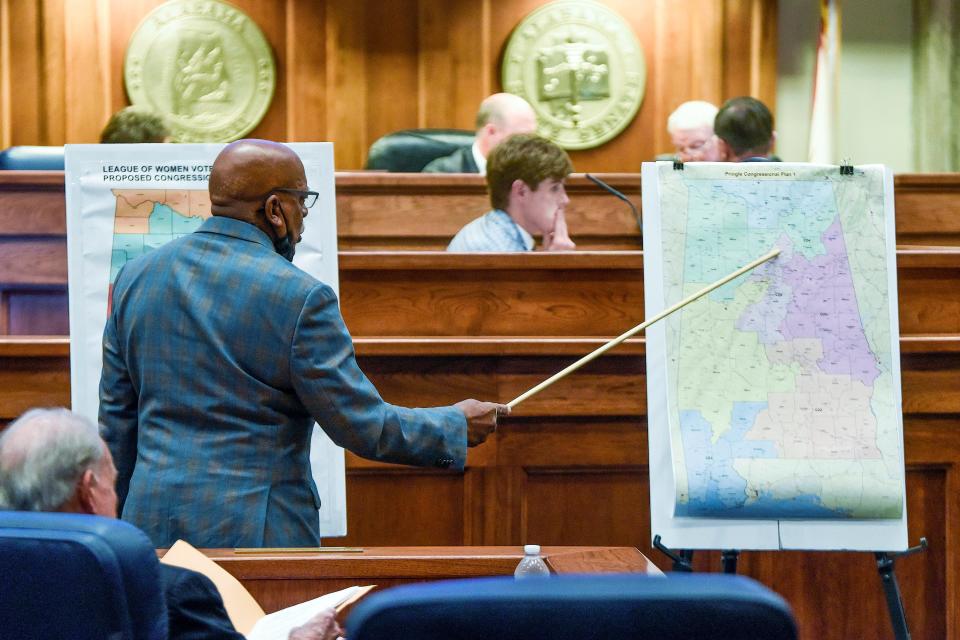 Alabama state Sen. Rodger Smitherman compares U.S. Representative district maps during a special session on redistricting at the Alabama Statehouse in Montgomery in November. Federal judges have blocked Alabama from using newly drawn congressional districts in upcoming elections. A three-judge panel issued a preliminary injunction on Jan. 24.