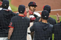 Cleveland Indians' Jose Ramirez is congratulated by teammates after the Indians defeated the Chicago White Sox 5-4 in a baseball game Thursday, Sept. 24, 2020, in Cleveland. (AP Photo/Tony Dejak)