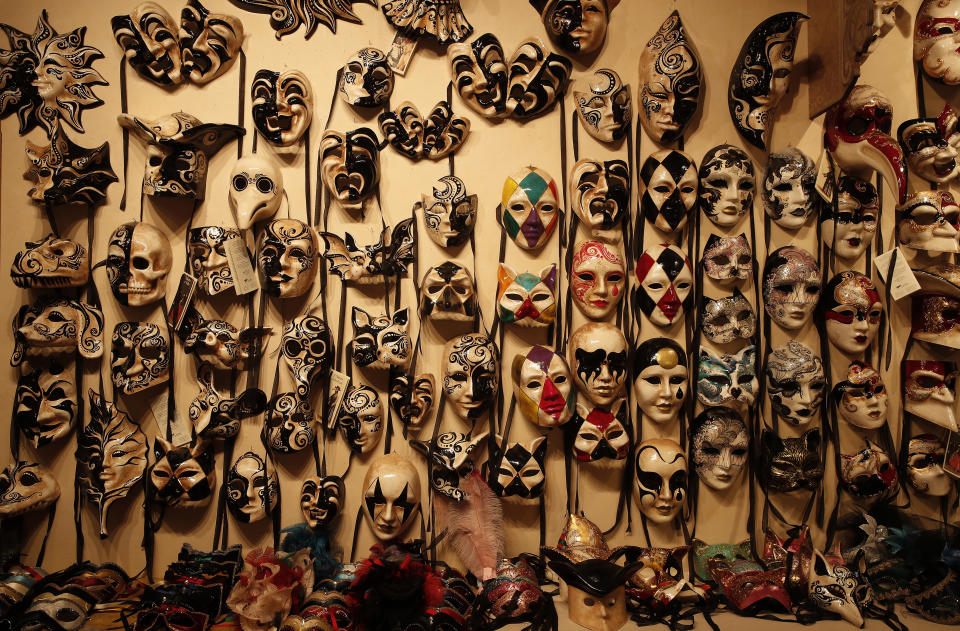 Carnival masks placed on display in a Venetian artisan mask makers shop in Venice, Italy, Saturday, Jan. 30, 2021. Last year, with fear over the new coronavirus mounting, authorities abruptly shut down Venice Carnival on its third day, just before Italy became the first country in the West facing a outbreak. (AP Photo/Antonio Calanni)