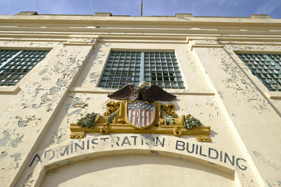 In this photo taken Tuesday, Nov. 12, 2019, the word "Free" is painted below an eagle figure that hangs on the entryway to the main cell house on Alcatraz Island in San Francisco. The words were added during the Native American occupation of the island. The week of Nov. 18, 2019, marks 50 years since the beginning of a months-long Native American occupation at Alcatraz Island in the San Francisco Bay. The demonstration by dozens of tribal members had lasting effects for tribes, raising awareness of life on and off reservations, galvanizing activists and spurring a shift in federal policy toward self-determination. (AP Photo/Eric Risberg)