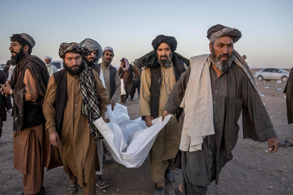 Afghan people carry the body of a relative killed in an earthquake to a burial site after an earthquake in Zenda Jan district in Herat province, western of Afghanistan, Monday, Oct. 9, 2023. Saturday's deadly earthquake killed and injured thousands when it leveled an untold number of homes in Herat province. (AP Photo/Ebrahim Noroozi)
