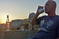 Saad Hussein, an Iraqi Yazidi, drinks Arak that he produces out of dates, on the outskirts of Mosul