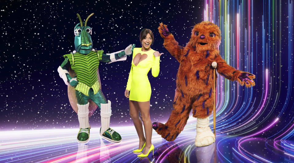 This image and the information contained herein is strictly embargoed until 21.00 Sunday 10th December 2023..From Bandicoot TV..The Masked Singer: SR5 on ITV1 and ITVX..Pictured: Davina McCall, Kricket & Bigfoot..This photograph is (C) ITV Plc/Bandicoot TV and can only be reproduced for editorial purposes directly in connection with the programme or event mentioned above, or ITV plc. This photograph must not be manipulated [excluding basic cropping] in a manner which alters the visual appearance of the person photographed deemed detrimental or inappropriate by ITV plc Picture Desk. This photograph must not be syndicated to any other company, publication or website, or permanently archived, without the express written permission of ITV Picture Desk. Full Terms and conditions are available on the website www.itv.com/presscentre/itvpictures/terms..For further information please contact:.michael.taiwo1@itv.com