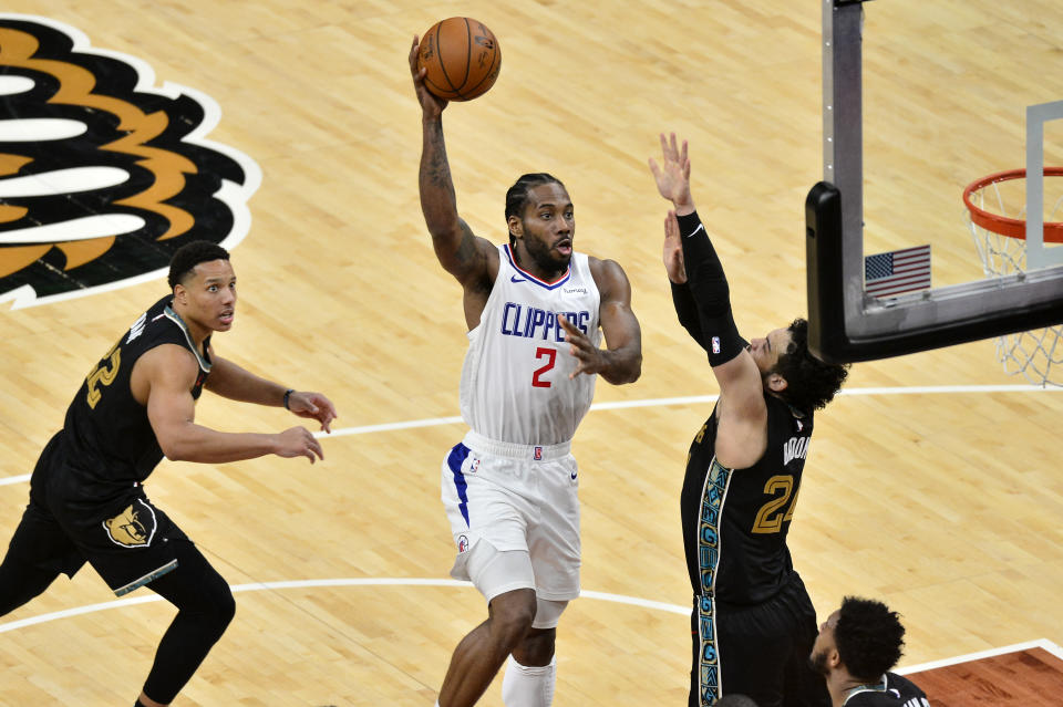 Los Angeles Clippers forward Kawhi Leonard (2) shoots between Memphis Grizzlies guards Dillon Brooks (24) and Desmond Bane (22) during the second half of an NBA basketball game Friday, Feb. 26, 2021, in Memphis, Tenn. (AP Photo/Brandon Dill)