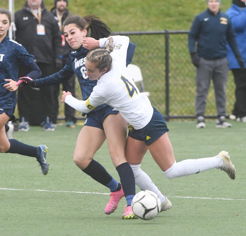 Lindsay Lenhard of Spencerport gets taken down by Smithtown West's Courtney Vercillo in the second half.