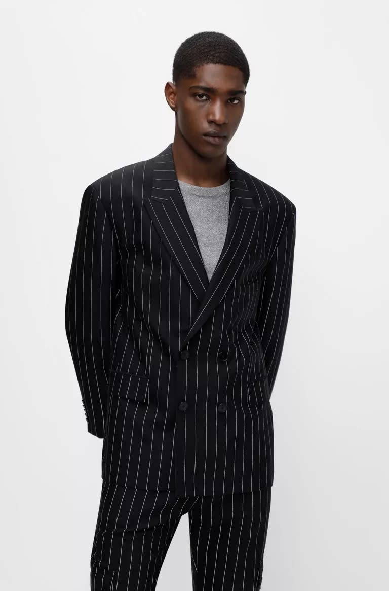 Model wearing a black and grey striped HUGO Boss suit