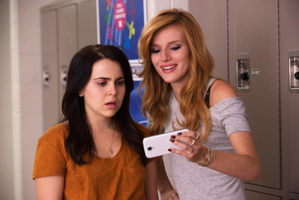 Mae Whitman and Bella Thorne looking at Bella's phone while Mae looks shocked