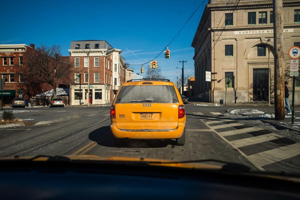Taxi driver Miguel Cerrato waits at traffic light behind another taxi cab on Liberty Street in Newburgh. Cerrato is president of the Independent Taxi Drivers Association – a group of Newburgh-based cabbies that formally organized last year. They led the lobby to raise the prices for rides.