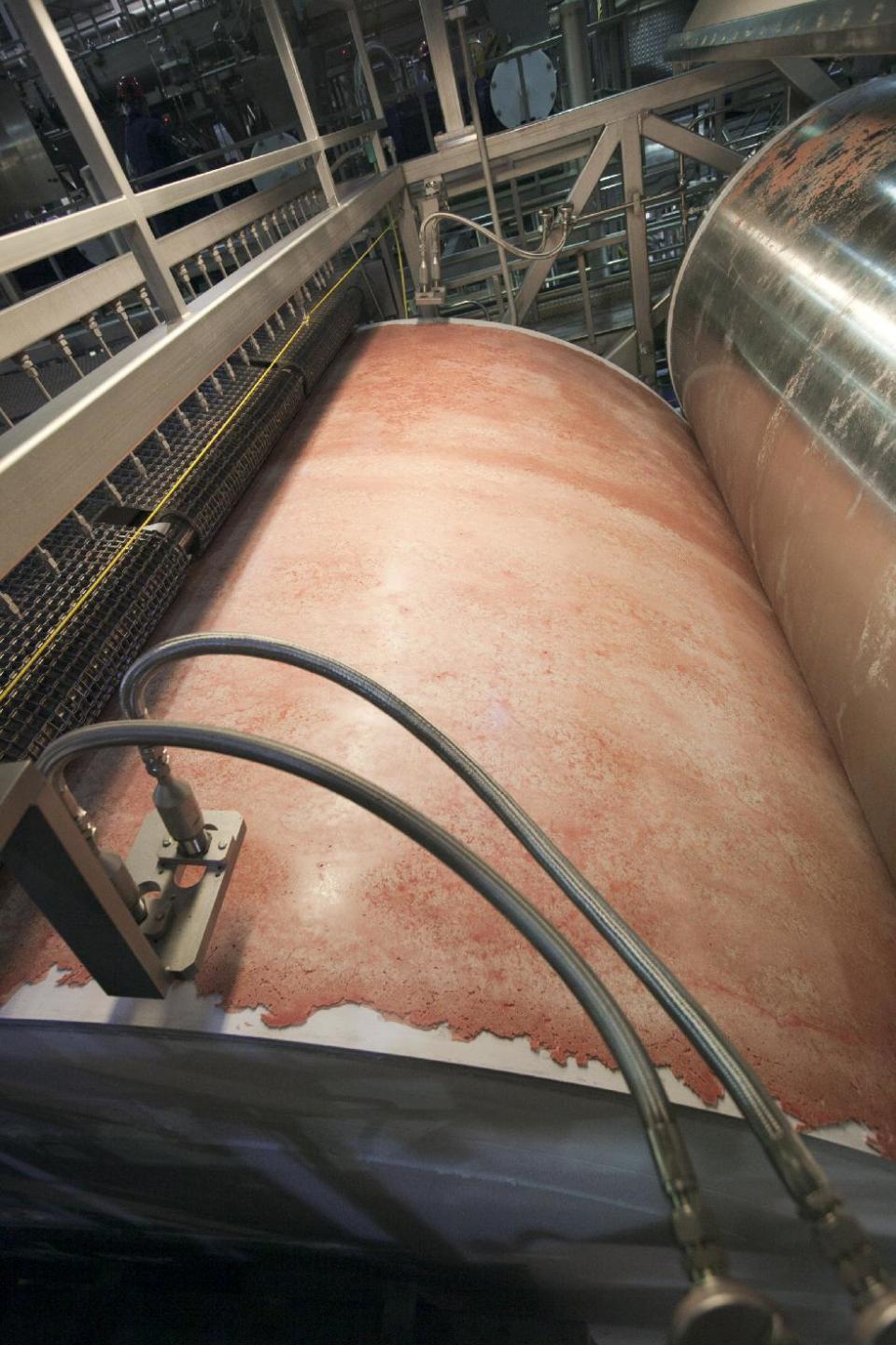 In this March 29, 2012 photo, the beef product known as lean finely textured beef, or "pink slime," is frozen on a large drum as part of its manufacturing process at the Beef Products Inc.'s plant in South Sioux City, Neb. Beef Products Inc. filed a defamation lawsuit against ABC News Thursday, Sept. 13, 2012, for its coverage of the meat product that critics have dubbed “pink slime,” alleging that the network misled consumers to believe the product is unhealthy and unsafe. (AP Photo/Nati Harnik)