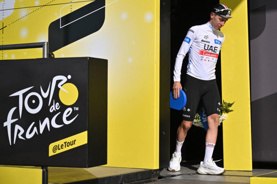 UAE Team Emirates' Slovenian rider Tadej Pogacar celebrates on the podium with the best young rider's white jersey after the 17th stage of the 110th edition of the Tour de France cycling race, 166 km between Saint-Gervais Mont-Blanc and Courchevel, in the French Alps, on July 19, 2023. (Photo by Marco BERTORELLO / AFP)