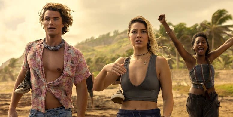 a boy and two girls standing on island beach