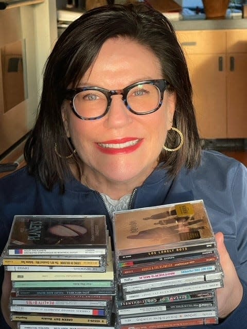 Perrin Kaplan, a Seattle, Washington, global communications and marketing executive, with some of the CDs in her collection.