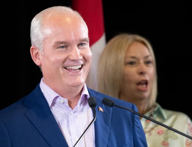 Conservative Leader Erin O'Toole Leader, left, smiles while answering a reporter's question during a news conference in Levis, Que., Saturday, Aug. 14, 2021. The Conservative Party released its 160-page platform Monday. (Jacques Boissinot/Canadian Press - image credit)