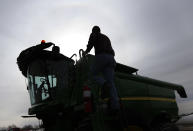 Nick Guetterman climbs into a combine on his farm near Bucyrus, Kan., Wednesday, Feb. 19, 2014. Farmers from across the nation gathered in Washington this month for their annual trek to seek action on the most important matters in American agriculture. But this time, a new issue emerged: growing unease about how the largest seed companies are gathering vast amount of data from sensors on tractors, combines and other farm equipment. The sensors measure soil conditions, seeding rates, crop yields and many other variables. (AP Photo/Orlin Wagner)