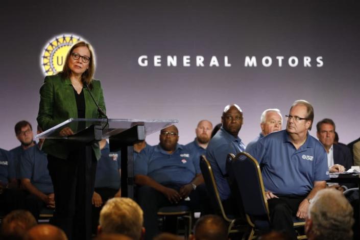 General Motors Chairman and CEO Mary Barra speaks while and United Auto Workers President Gary Jones (right) listens before they opened the 2019 GM-UAW contract talks with the traditional ceremonial handshake on July 16, 2019 in Detroit, Michigan. With its increasing investment in electric vehicles, GM is faced with the challenge of transitioning its employees to work with new technologies. (Photo by Bill Pugliano/Getty Images)