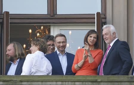 Leaders of the German Green Party Anton Hofreiter, Michael Kellner and Katrin Goering-Eckardt together with leaders of the Free Democratic Party (FDP) Christian Lindner and Wolfgang Kubicki are seen on the balcony of German Parliamentary Society offices prior to the exploratory talks with CDU/CSU about forming a new coalition government in Berlin, Germany, October 19, 2017. REUTERS/Axel Schmidt