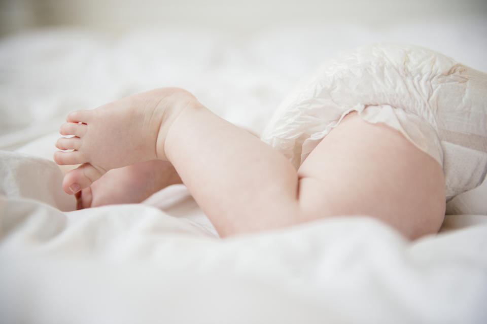 A baby's legs are pictured in a stock image.